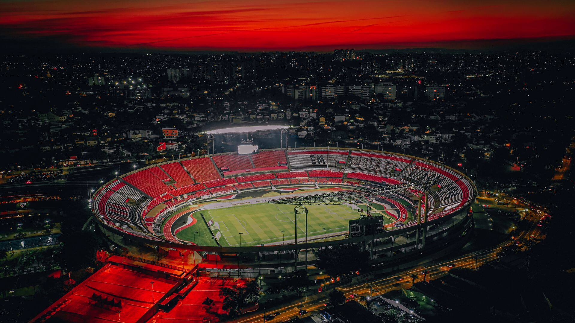 Football stadium under floodlights at night